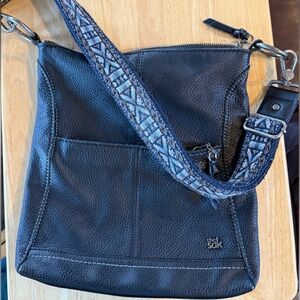 The Sak Black Leather Crossbody Bag with Woven Patterned Strap